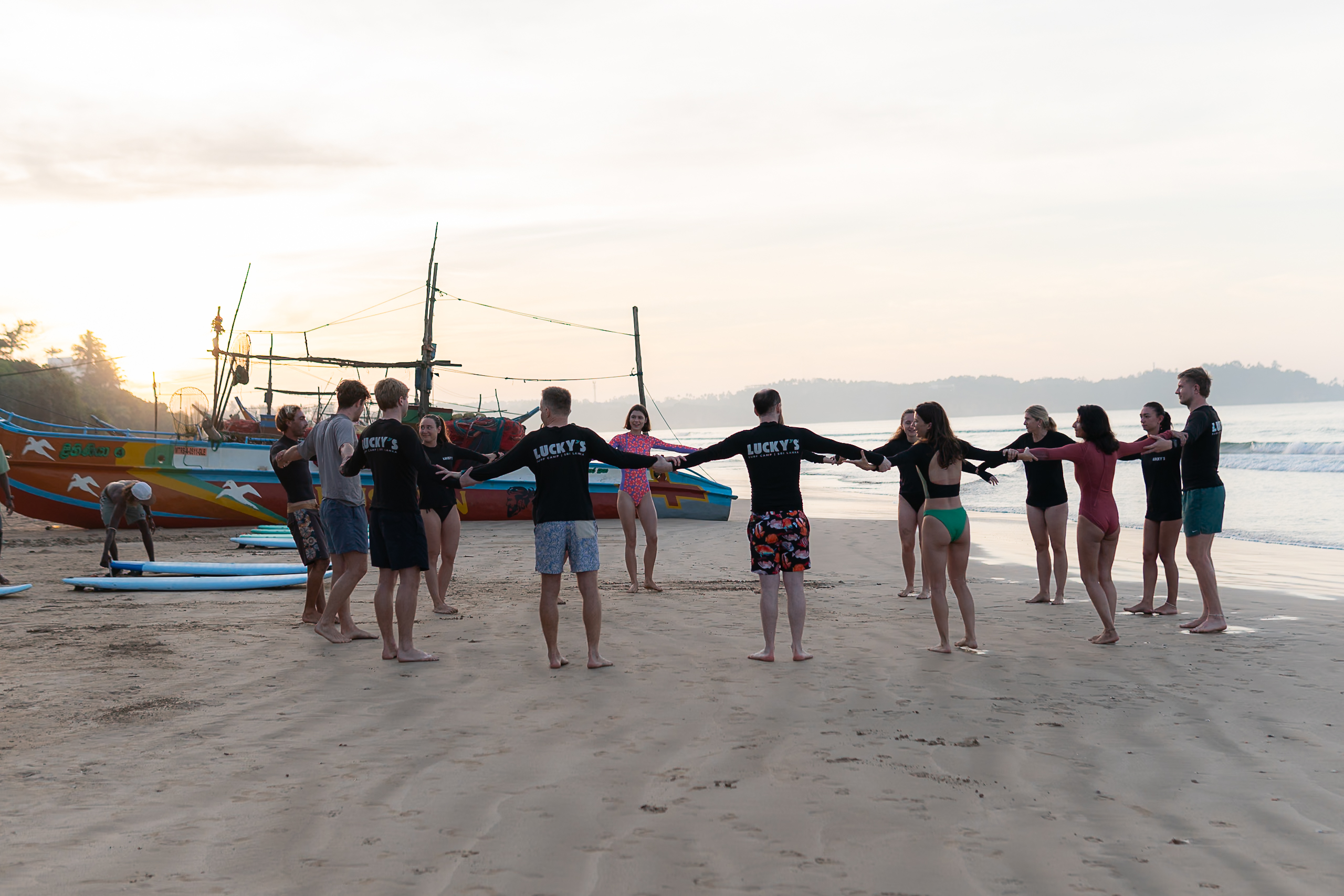 surfers warming up during surf lesson in weligama beginner surf spot